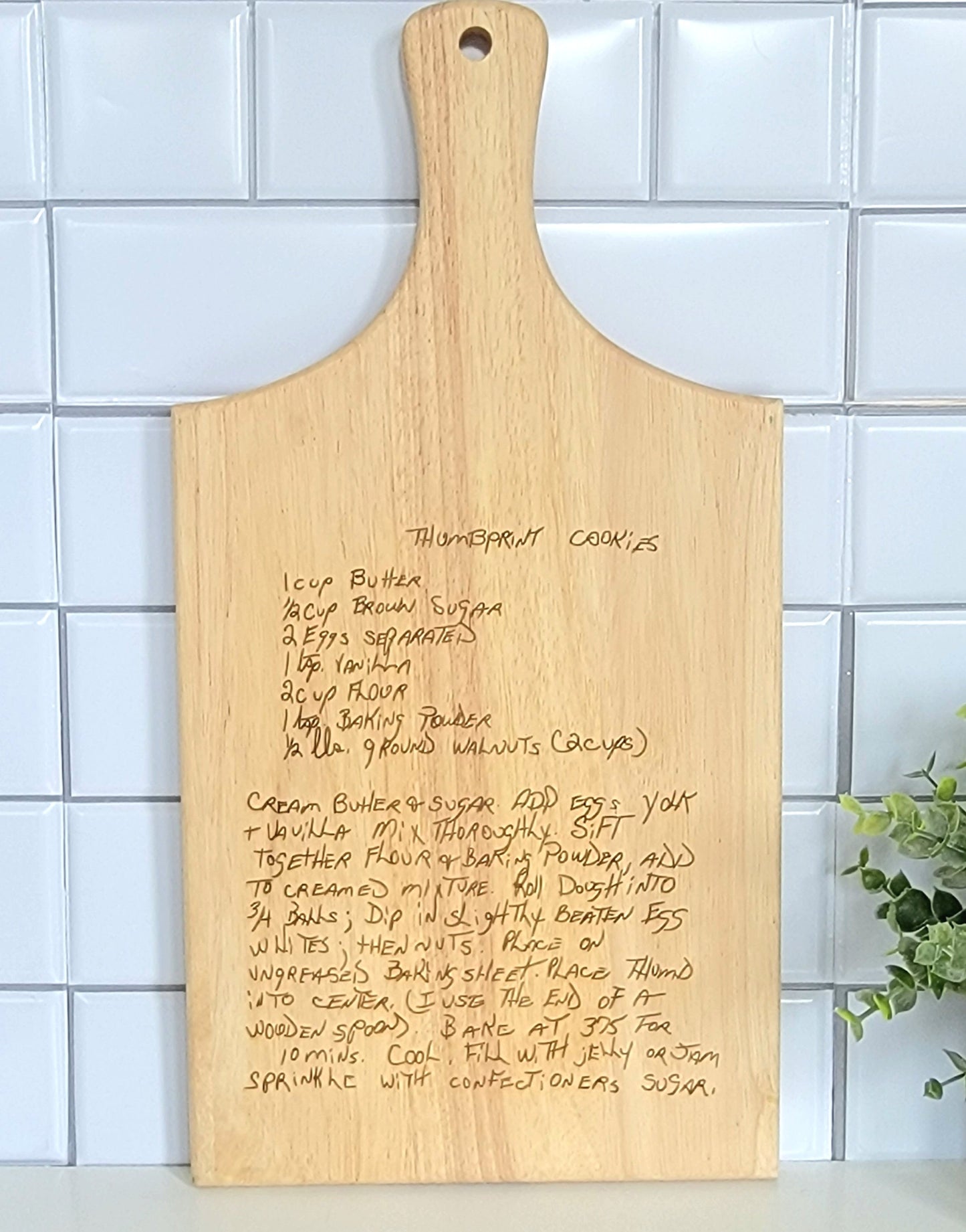 Handwritten recipe on a wooden cutting board, featuring handwriting from a family member or loved one.