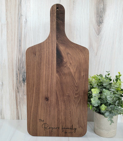 Elegant walnut cutting board with rich wood grain, showcasing a smooth surface and rounded edges. Size is 17 X 8.75. You have 6 available options to choose from for engraving. 