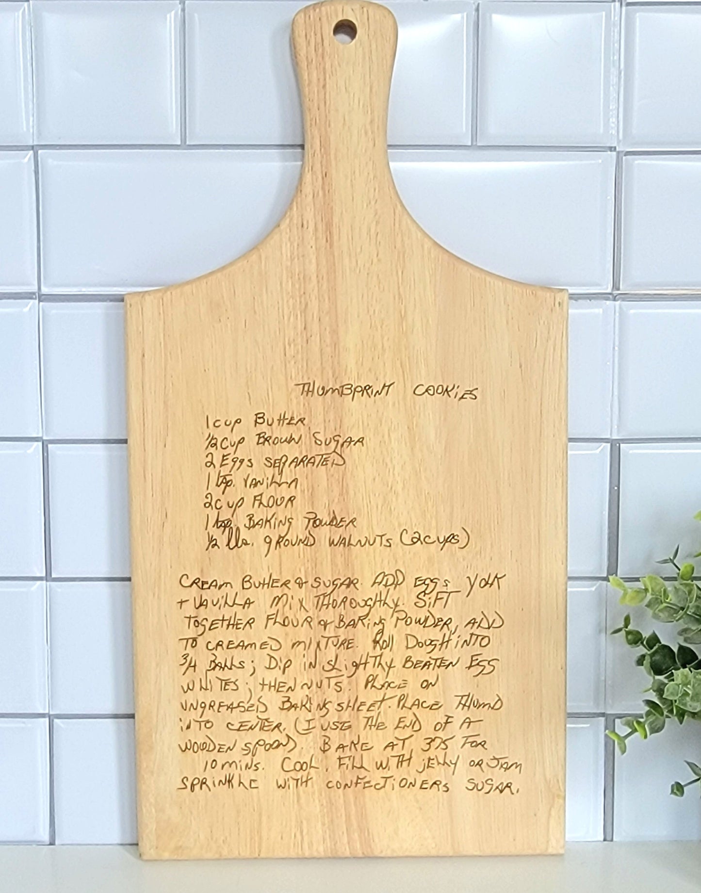 Handwritten recipe on a wooden cutting board, featuring  handwriting from a family member or loved one. 