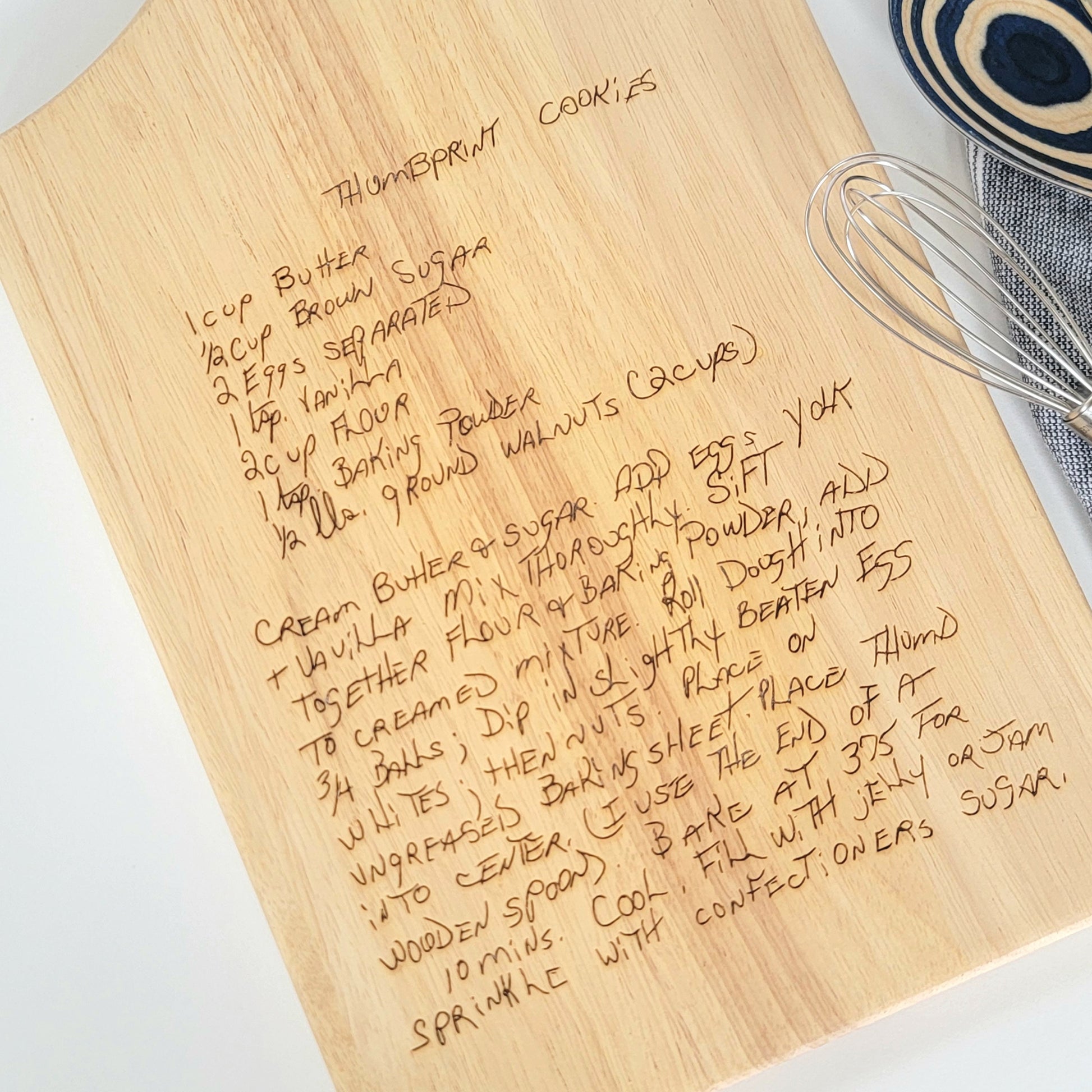 Handwritten recipe on a wooden cutting board, featuring  handwriting from a family member or loved one. 